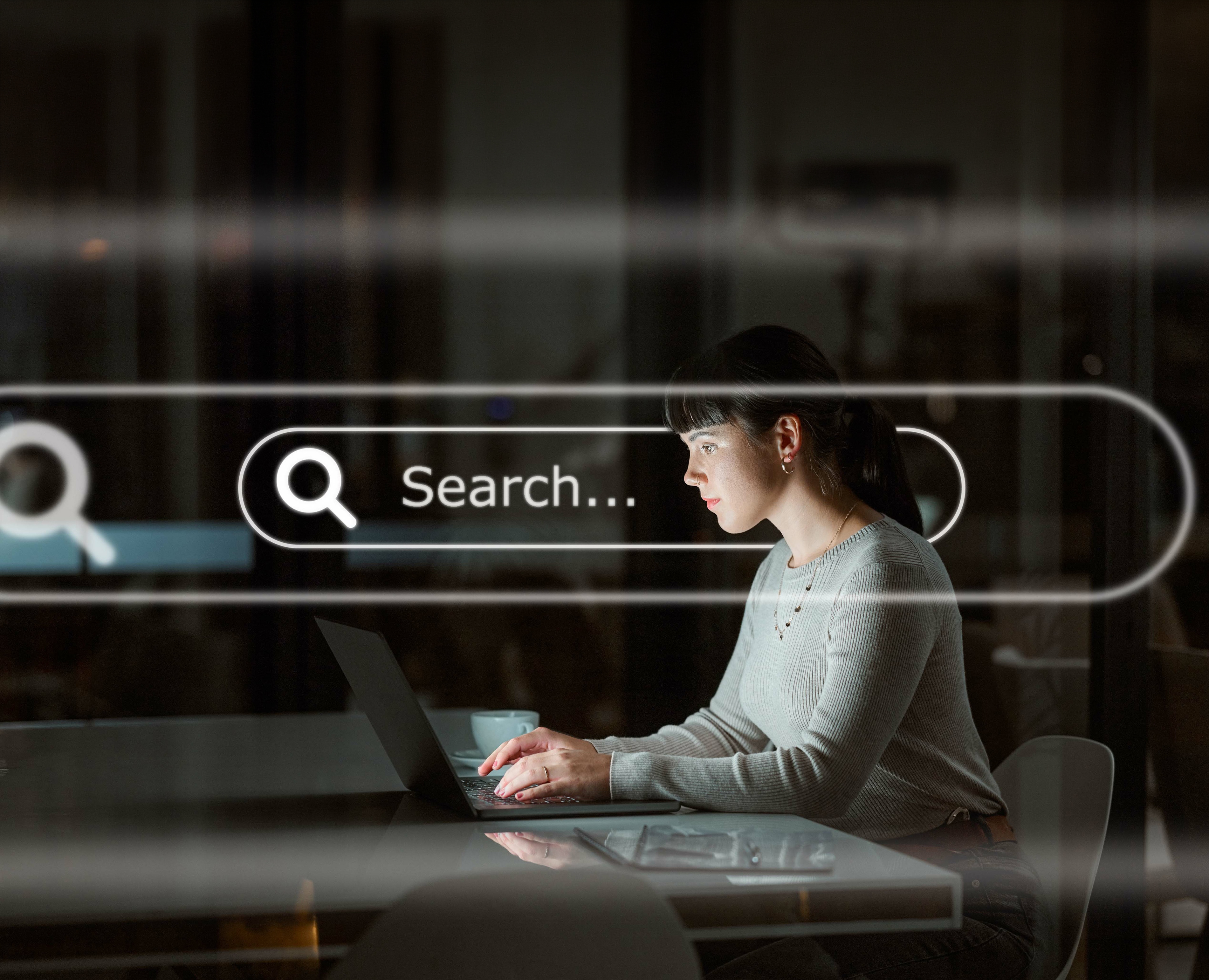 Marketer researching SEO data on a laptop at night